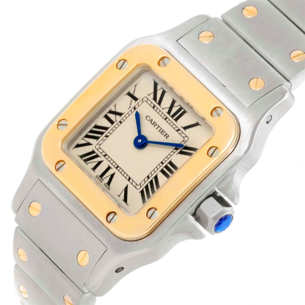 The Cartier Santos W20012C4 Women's Stainless Steel Silver Dial W20012C4 Women's Stainless Steel Silver Dial watch is shown at an angle that highlights its face, bezel, crown, and part of the bracelet.
