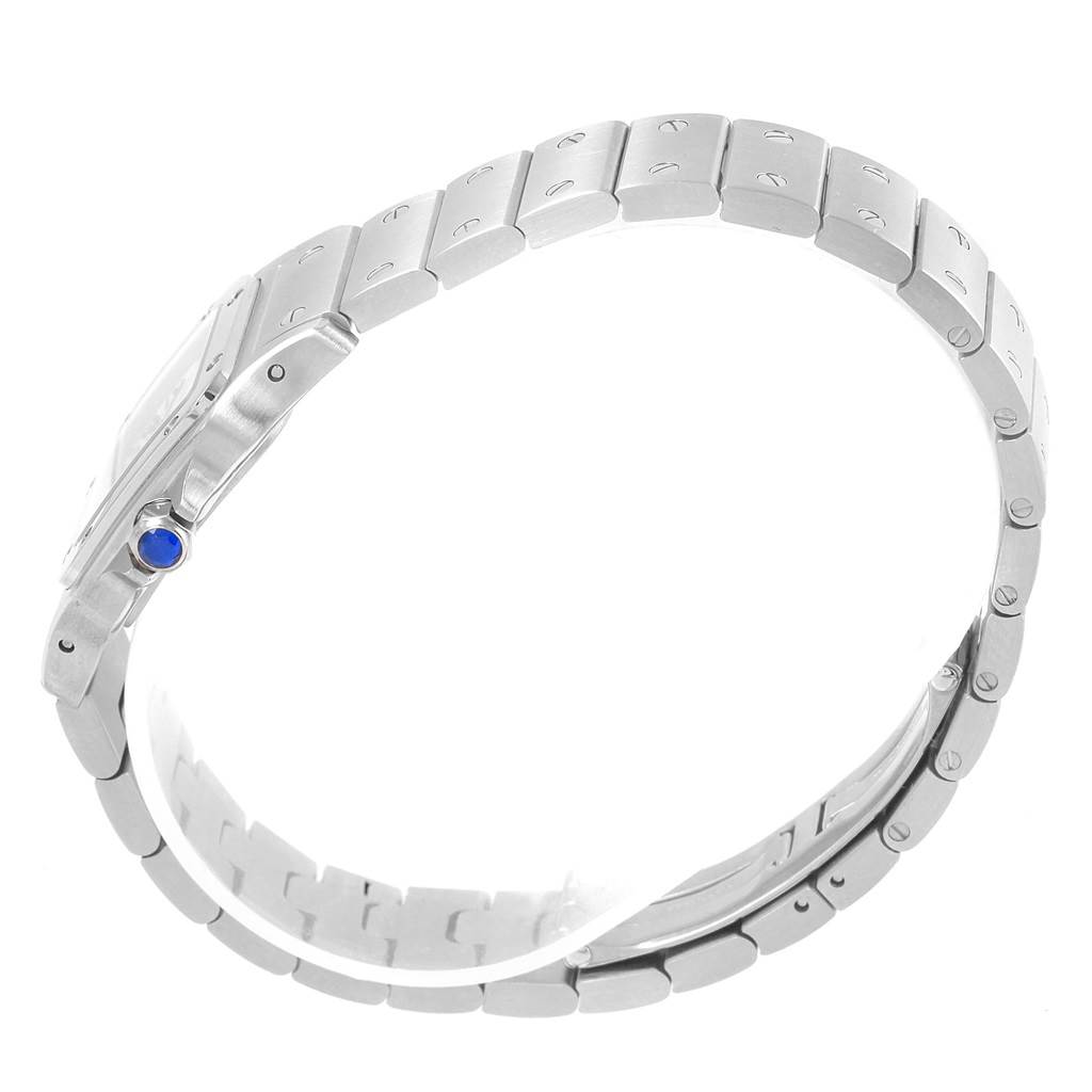 The image shows a side view of the Santos model watch by Cartier, highlighting its metal bracelet and blue crown.