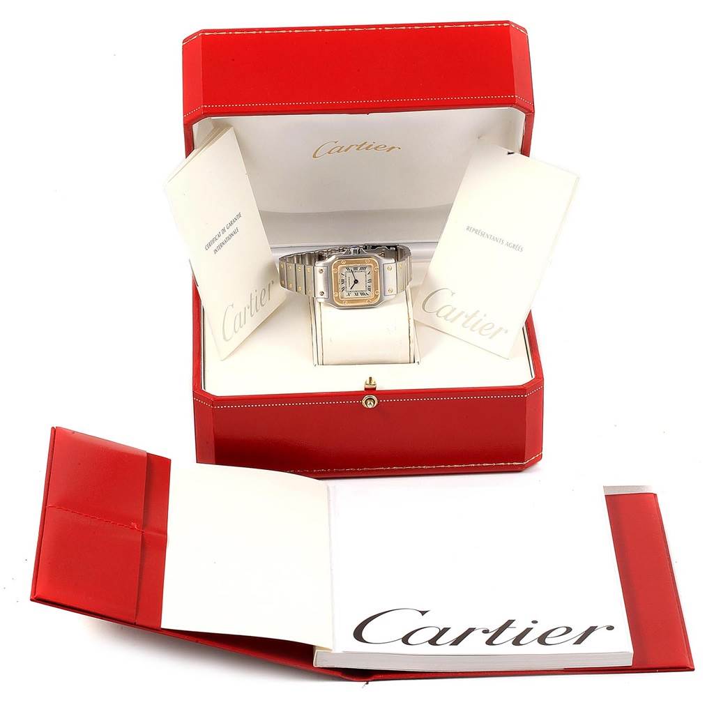 The image shows a Cartier Santos 1567 Women's Stainless Steel Silver Dial 1567 Women's Stainless Steel Silver Dial model watch placed in its red box, accompanied by documents.