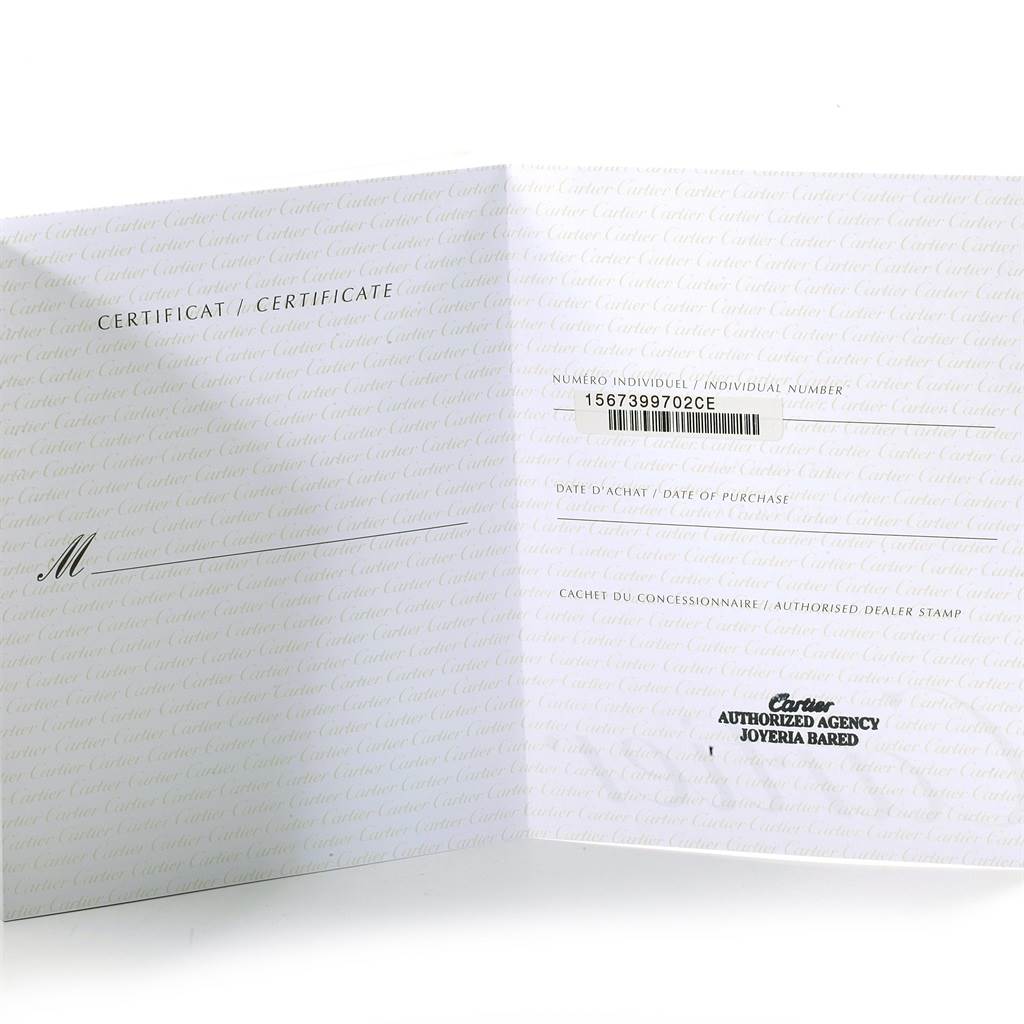 The image shows a certificate booklet for the Santos model by Cartier, displaying the individual number and authorized dealer stamp.