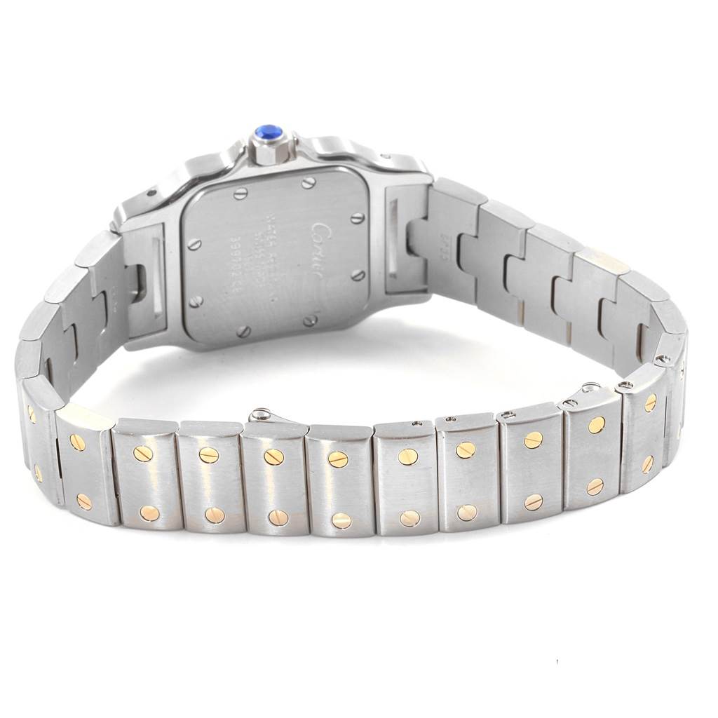 The image shows the backside and bracelet of the Santos model watch by Cartier, highlighting the case back and metal links.