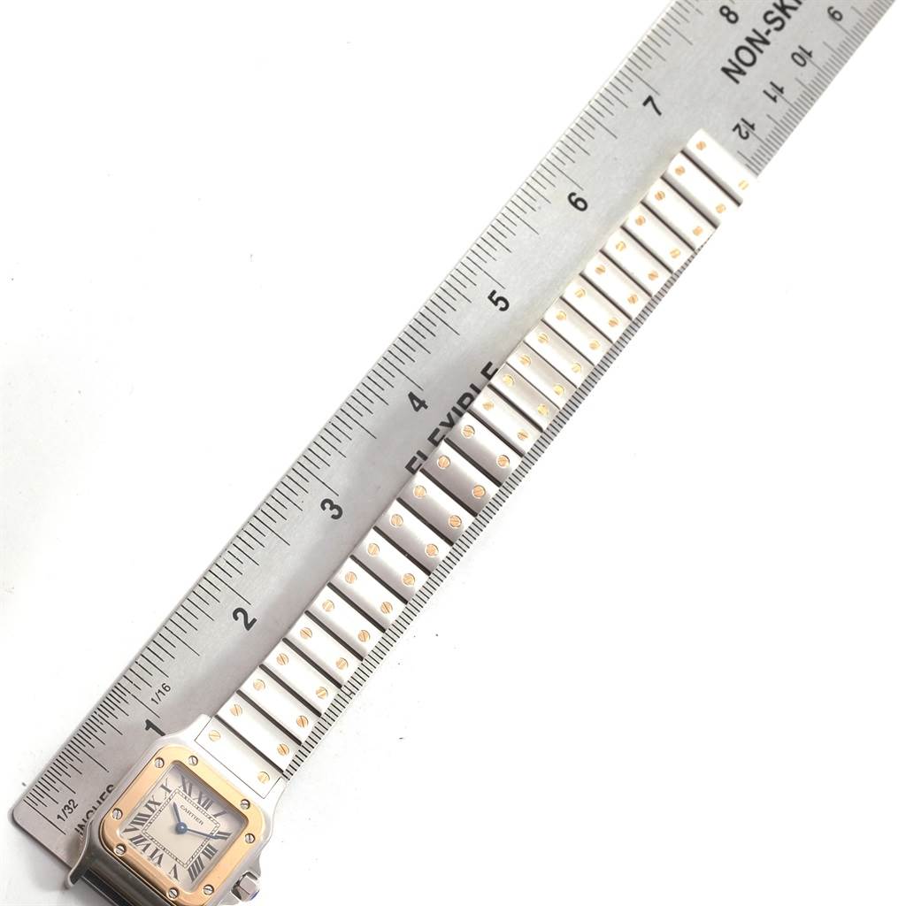 The image shows the face and part of the band of a Cartier Santos W20012C4 Women's Stainless Steel Silver Dial W20012C4 Women's Stainless Steel Silver Dial model watch, measured with a ruler.