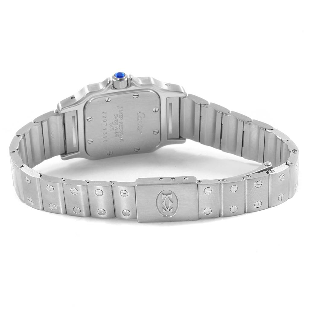 The image shows the back view of a Santos model by Cartier, highlighting the metal strap and clasp.