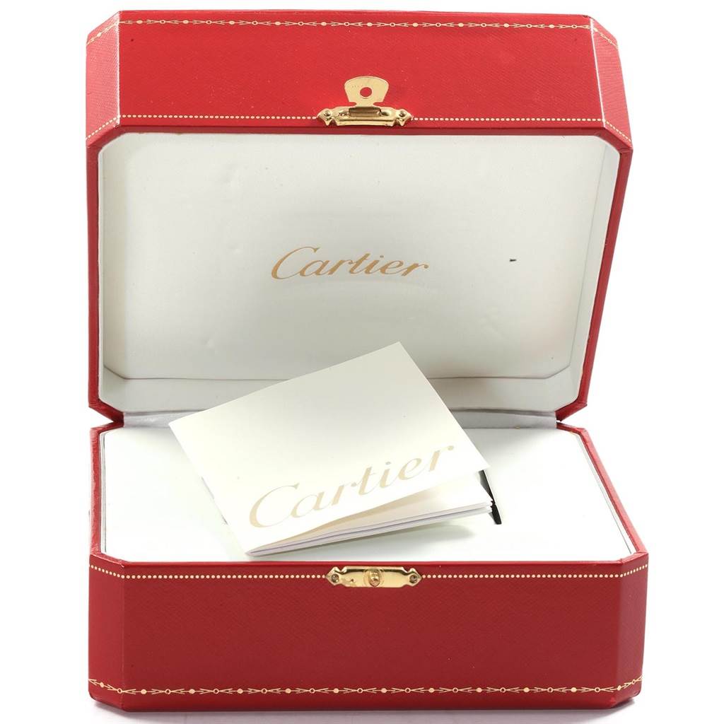 This image shows an open red Cartier watch box with a manual, presumably for the Santos model by Cartier.