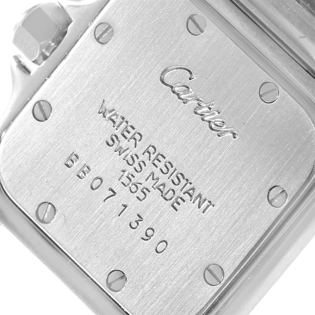 This image shows the case back of the Santos model by Cartier, angled to display the inscriptions and screws.