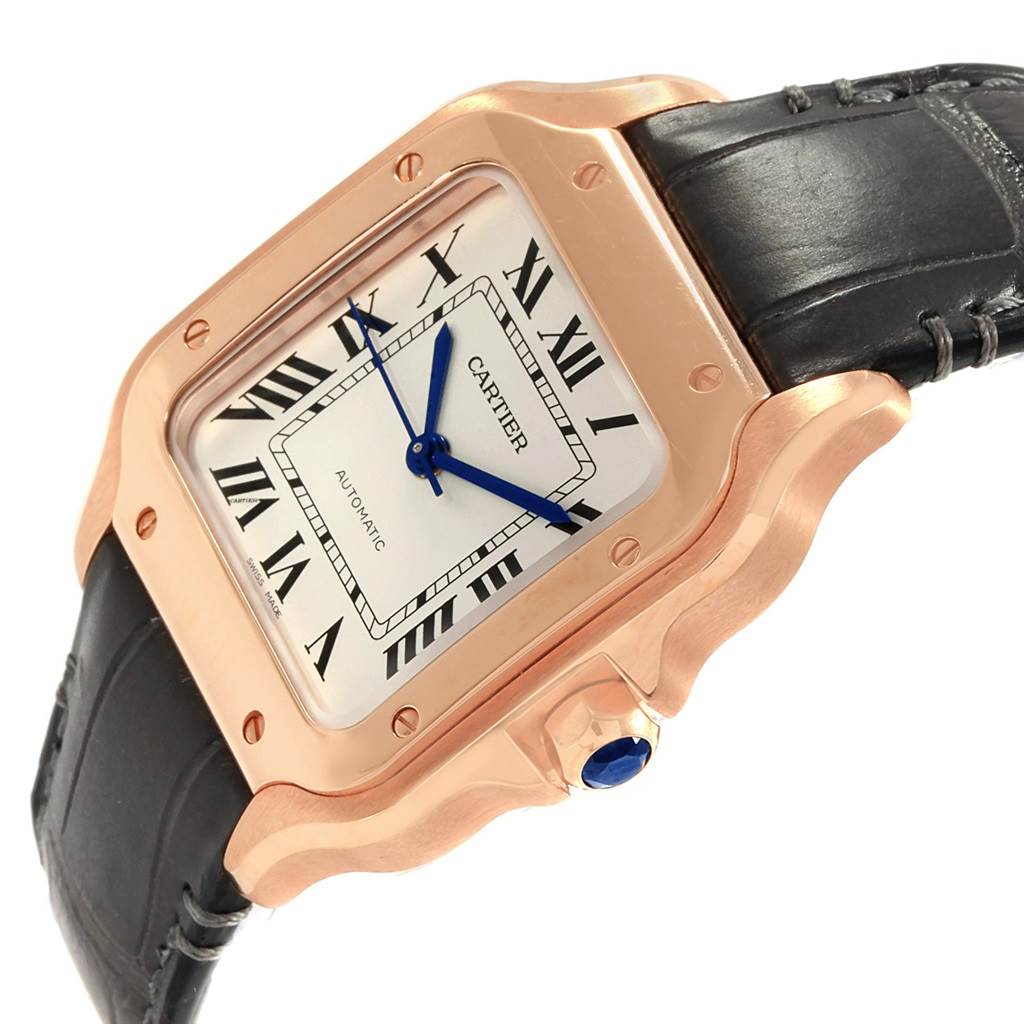 This image shows a Cartier Santos WGSA0012 Women's Rose Gold Silver Dial WGSA0012 Women's Rose Gold Silver Dial watch from an angled view, highlighting its face, bezel, crown, and leather strap.