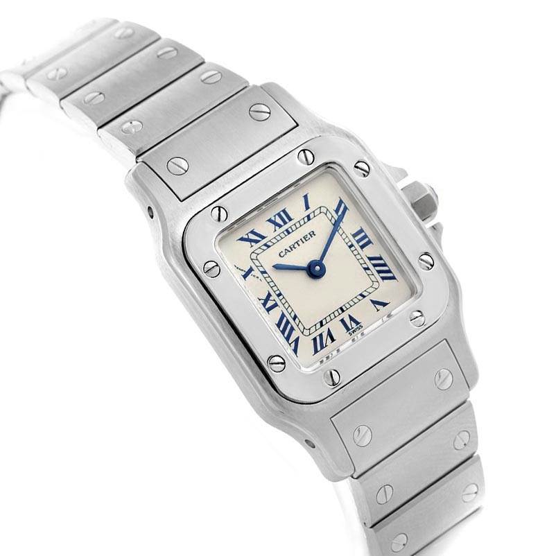 The image shows a close-up angle of the face and bracelet of the Cartier Santos 1565 Women's Stainless Steel Silver Dial 1565 Women's Stainless Steel Silver Dial watch.