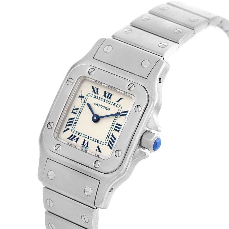 This image shows a close-up, angled view of a Cartier Santos 1565 Women's Stainless Steel Silver Dial 1565 Women's Stainless Steel Silver Dial wristwatch, displaying its face, crown, and bracelet.