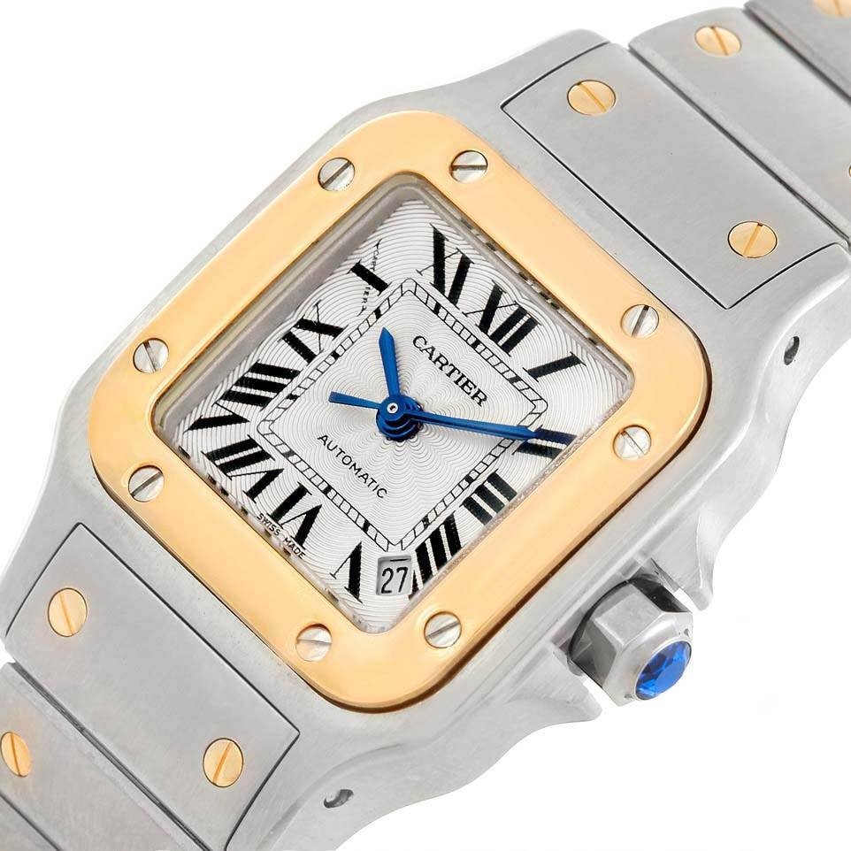 The image shows a close-up angle of the Cartier Santos W20057C4 Women's Stainless Steel Silver Dial W20057C4 Women's Stainless Steel Silver Dial watch, highlighting the dial, bezel, crown, and part of the strap.