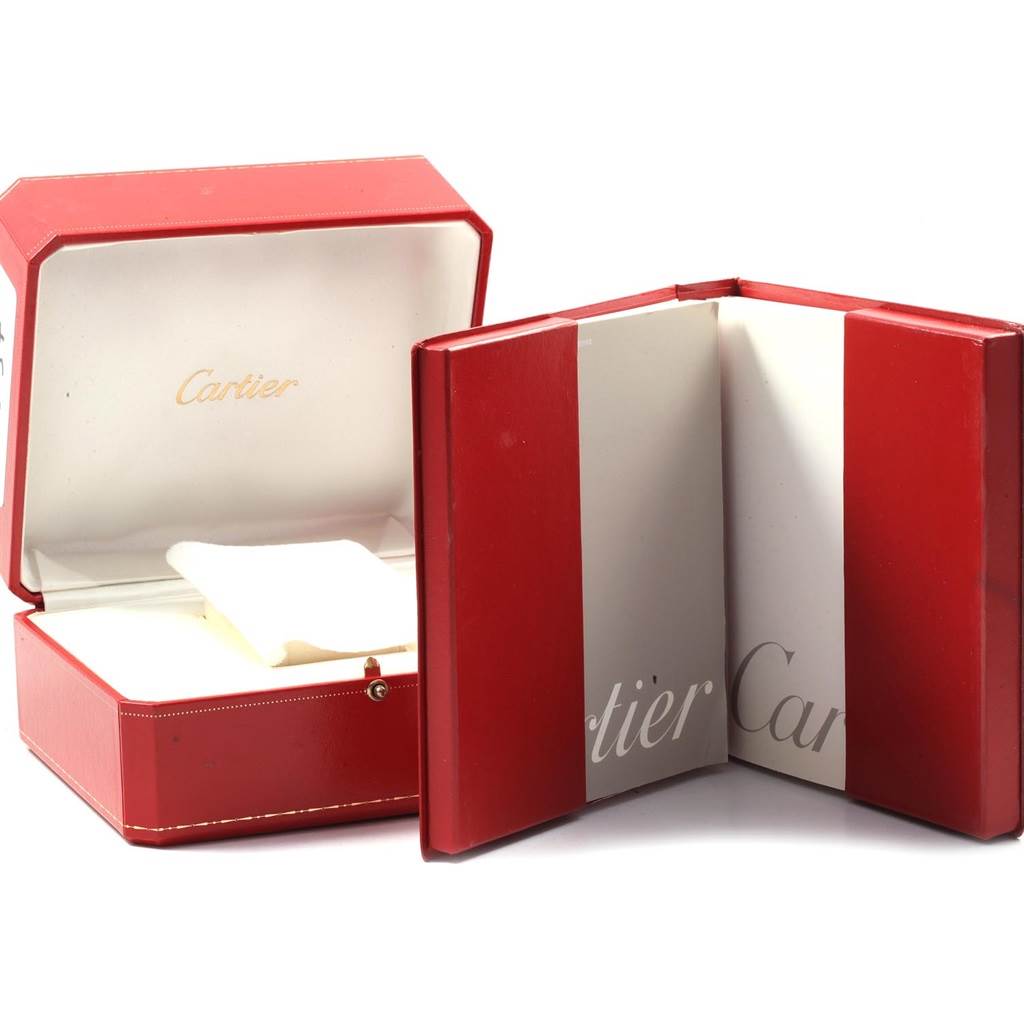The image shows an open red Cartier box and a red booklet for the Santos model by Cartier.