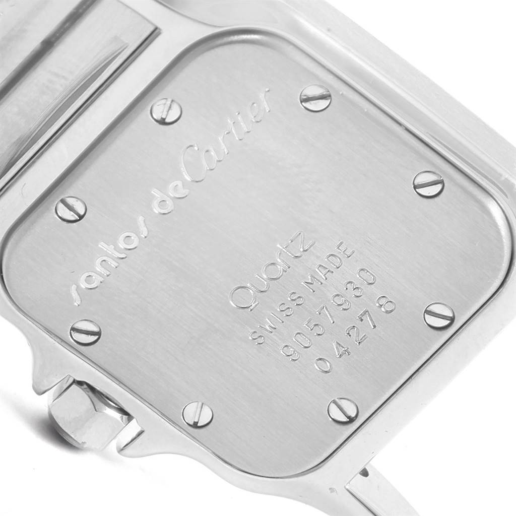 This image shows the back case of a Santos de Cartier watch, focusing on inscriptions and screws.