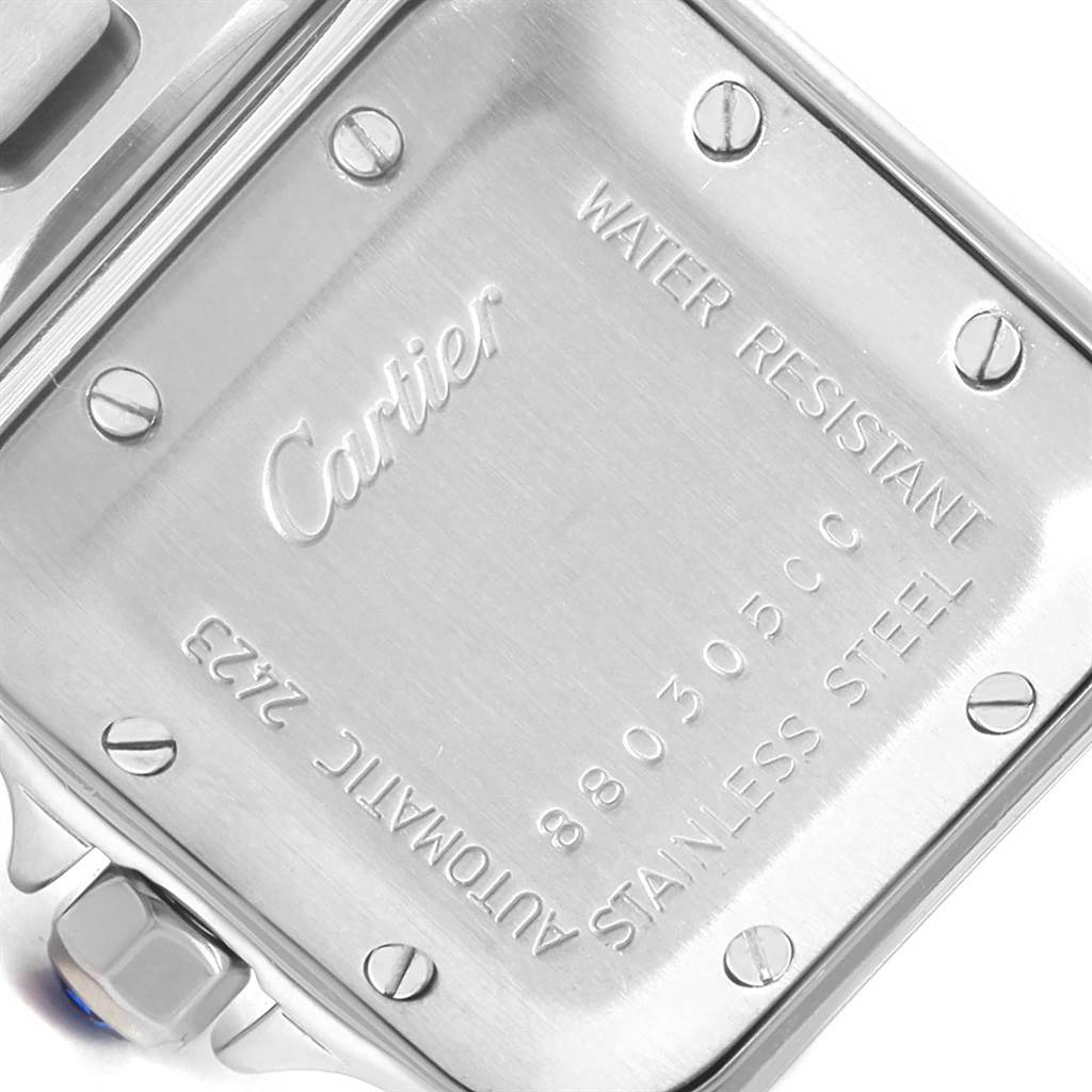 The image shows the back side of a Santos model watch by Cartier, highlighting the case back and its engravings.
