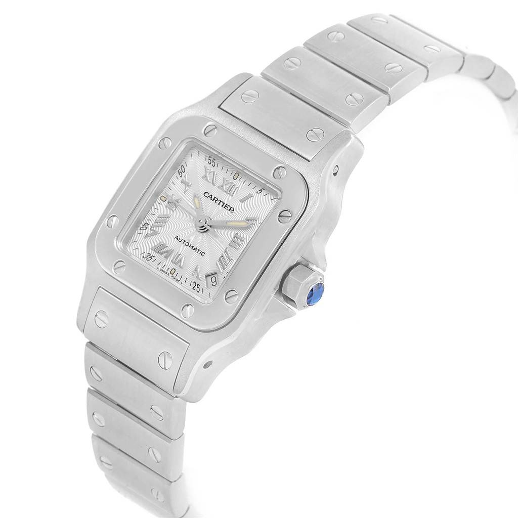 The image shows a Santos model watch by Cartier, viewed from an angled perspective, highlighting the face, bezel, and part of the bracelet.