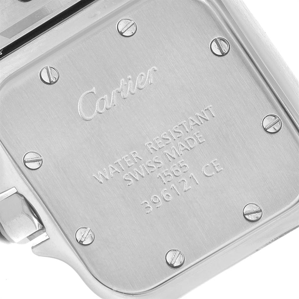The image shows the caseback of a Cartier Santos W20056D6 Women's Stainless Steel Silver Dial W20056D6 Women's Stainless Steel Silver Dial watch with engraved details and screw heads.