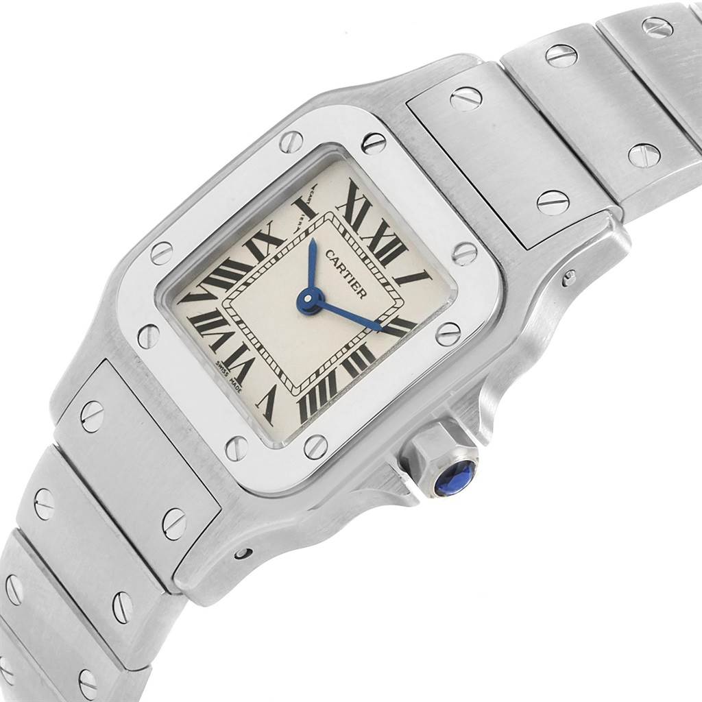This image shows a close-up angle of the face, bezel, crown, and part of the bracelet of a Cartier Santos W20056D6 Women's Stainless Steel Silver Dial W20056D6 Women's Stainless Steel Silver Dial watch.