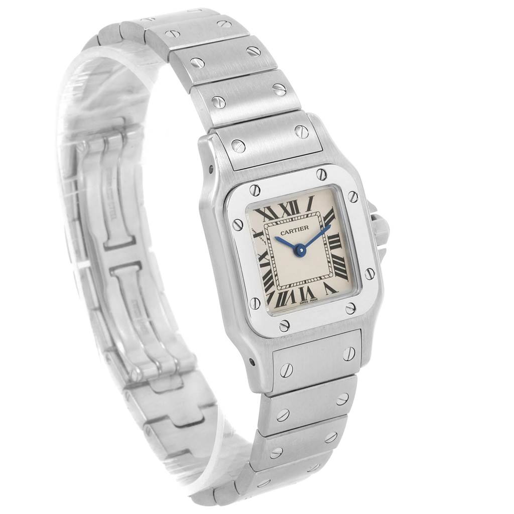 The Santos model by Cartier is shown at an angle displaying its stainless steel bracelet, case, and dial with Roman numerals.