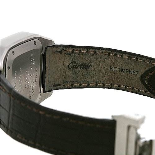 The image shows the back of the Santos model by Cartier, focusing on the case back and leather strap.