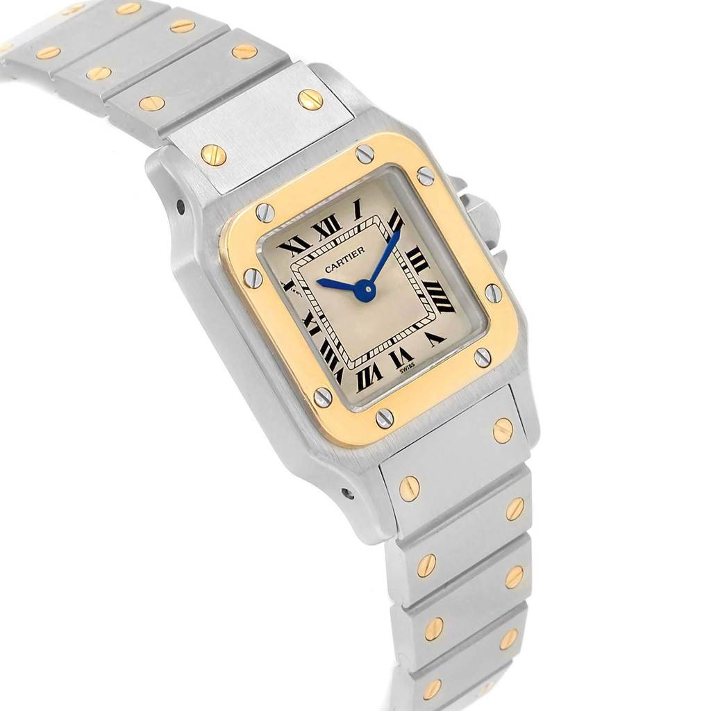 The image shows a Cartier Santos 1057930 Women's Stainless Steel Silver Dial 1057930 Women's Stainless Steel Silver Dial watch angled to display its square face, bezel, and part of its metallic bracelet.