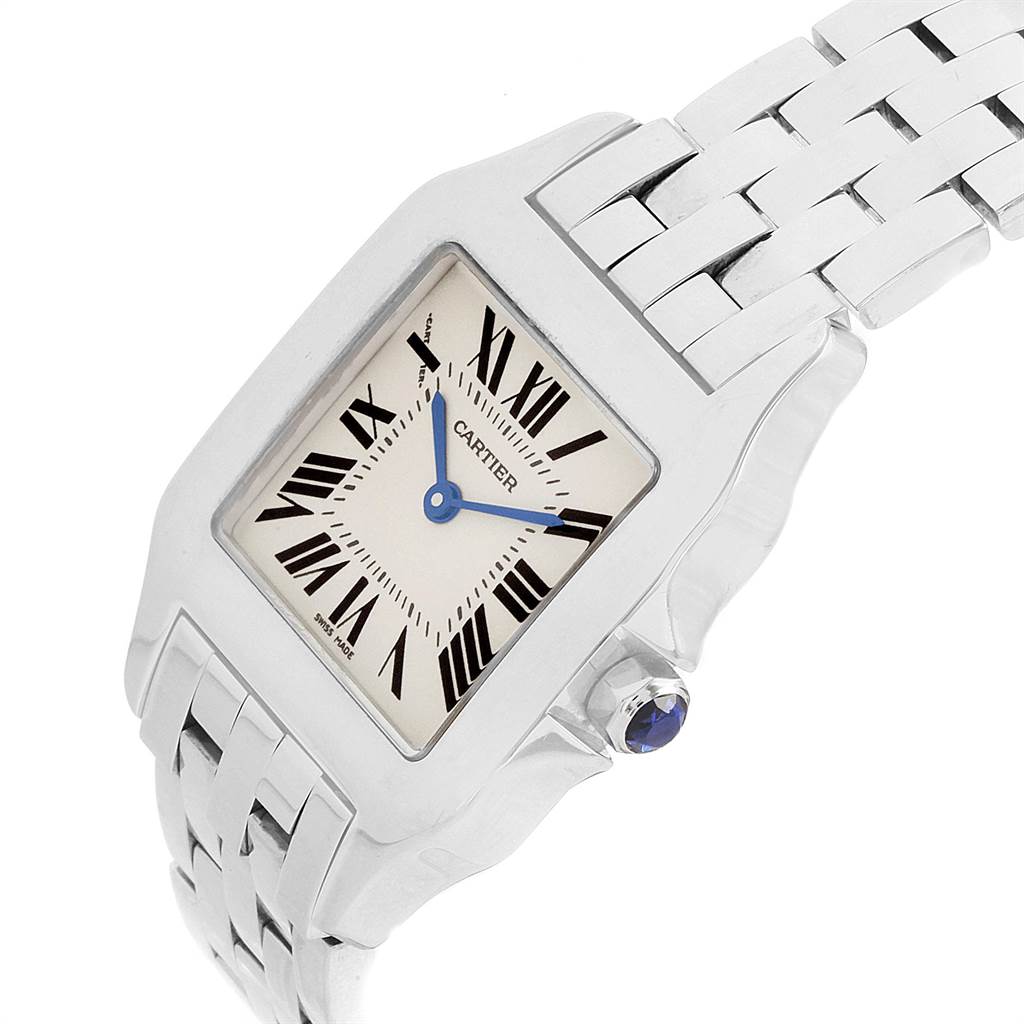This image shows a Cartier Santos W25065Z5 Women's Stainless Steel Silver Dial W25065Z5 Women's Stainless Steel Silver Dial watch from a tilted angle, highlighting its face, crown, and part of the metal bracelet.