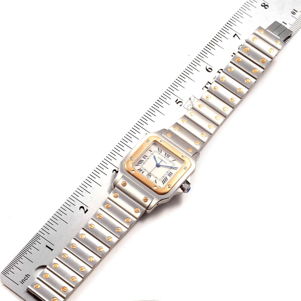 The image shows the front view of a Cartier Santos W20011C4 Stainless Steel Silver Dial W20011C4 Stainless Steel Silver Dial watch placed next to a ruler for measurement.