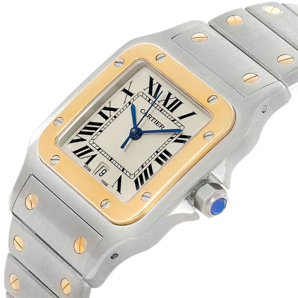 This image shows a close-up angled view of the Cartier Santos W20011C4 Stainless Steel Silver Dial W20011C4 Stainless Steel Silver Dial watch, featuring the dial, bezel, and part of the bracelet.