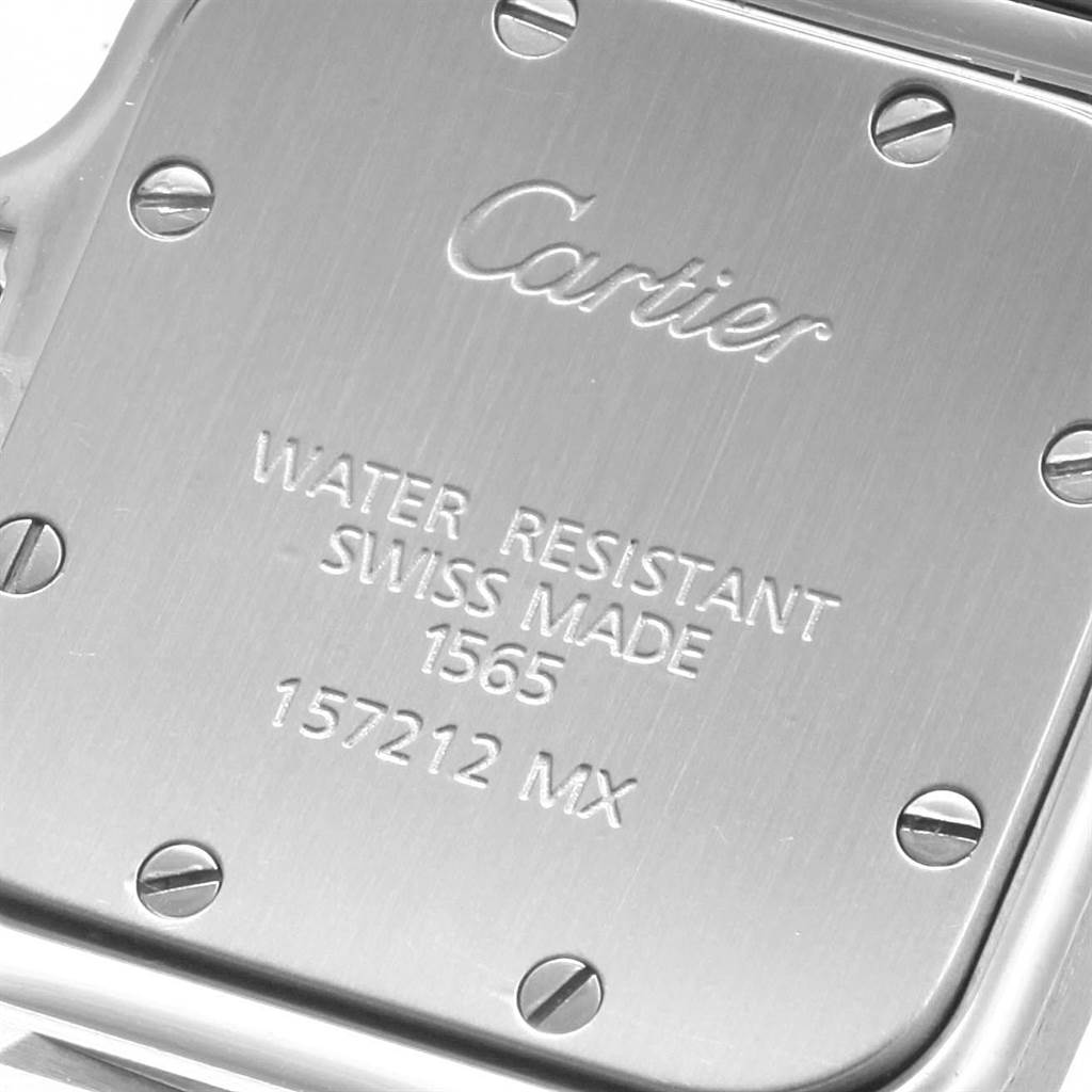This image shows the back case of a Santos model watch by Cartier, displaying the brand name, water resistance, and serial number.