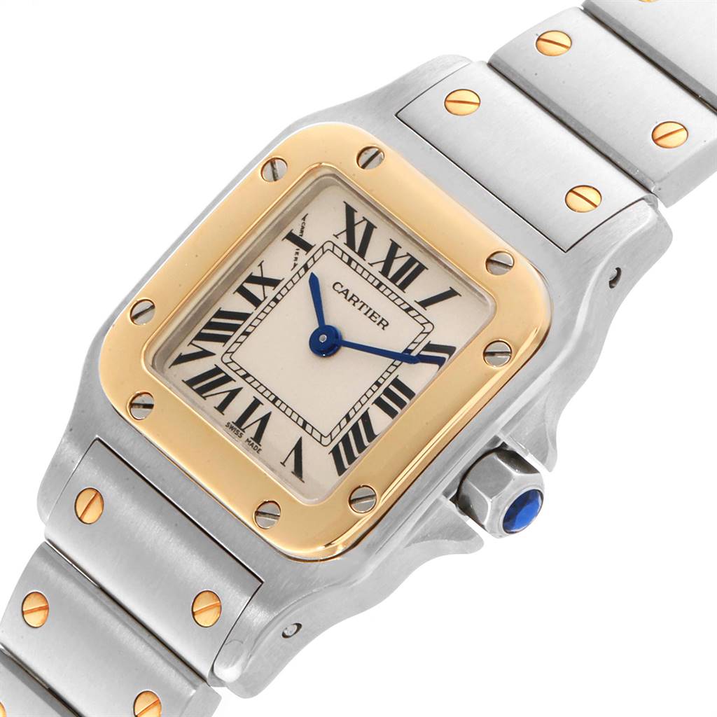 This image shows a close-up of the face and upper part of the bracelet of a Santos model watch by Cartier.