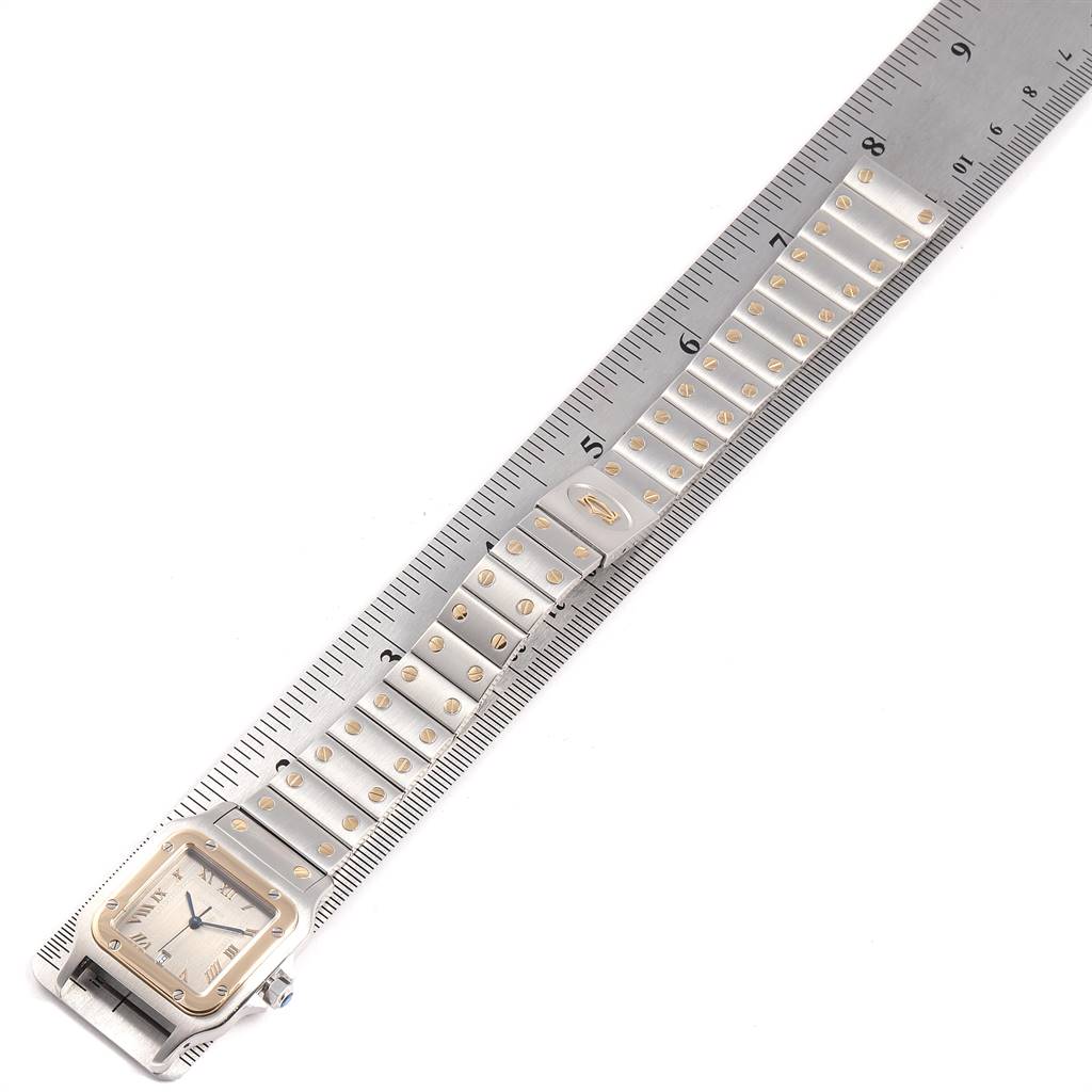 The image shows a Cartier Santos 1566 Stainless Steel Grey Dial 1566 Stainless Steel Grey Dial watch at a top-down angle, with its face, bezel, and bracelet aligned next to a ruler.