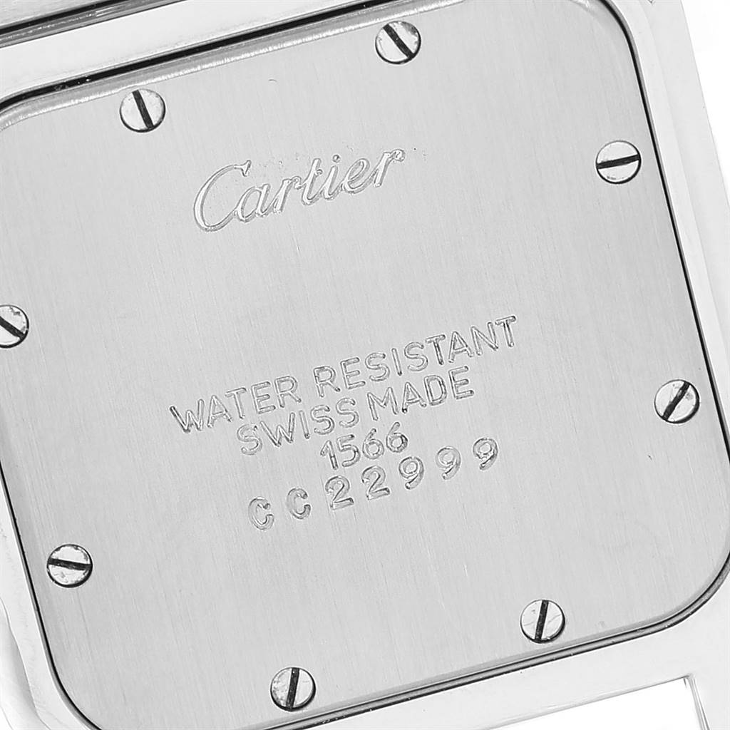 This image shows the back case of a Cartier Santos 1566 Stainless Steel Grey Dial 1566 Stainless Steel Grey Dial watch, displaying brand engravings and serial numbers.