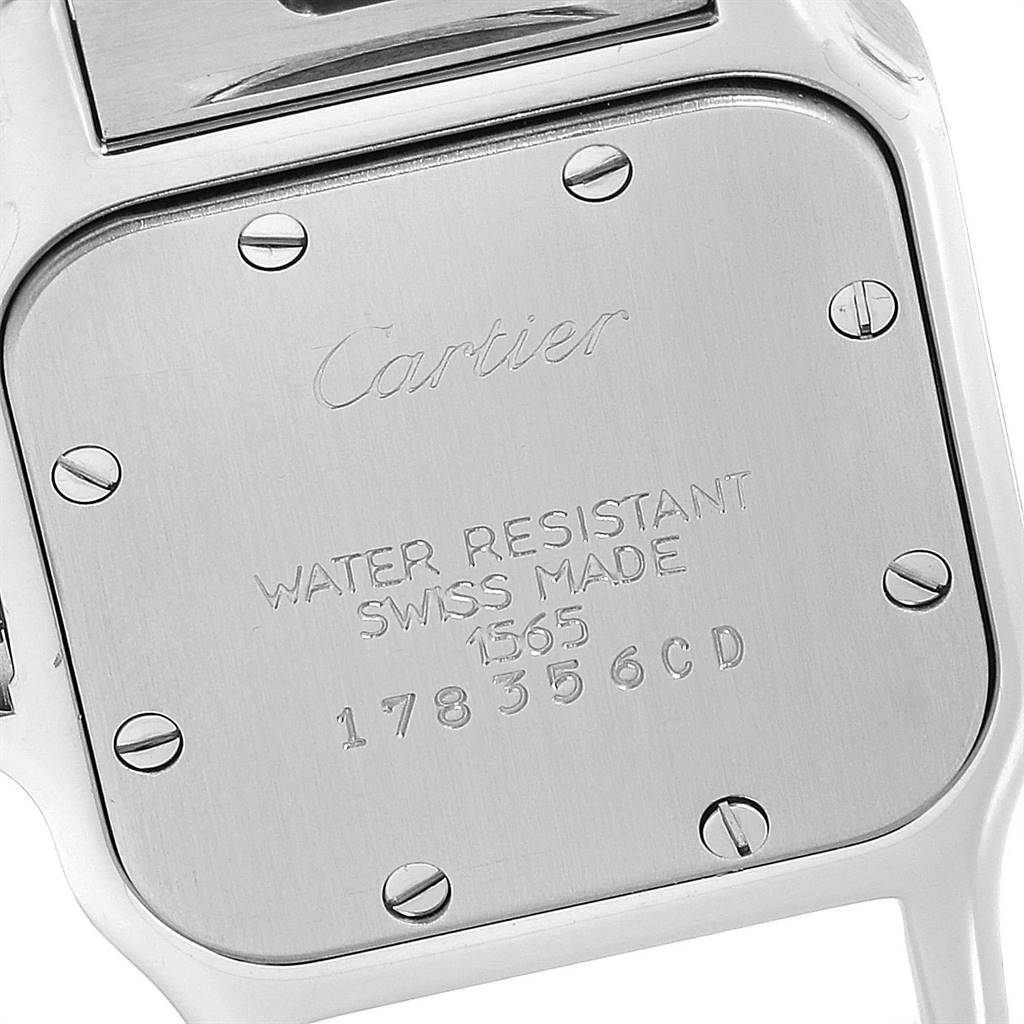 This image shows the case back of the Cartier Santos 1565 Women's Stainless Steel Silver Dial 1565 Women's Stainless Steel Silver Dial watch, featuring engraved text and screws.