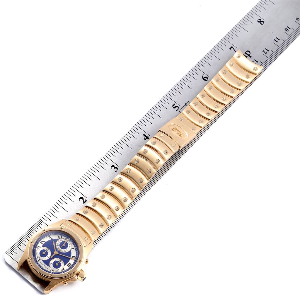 The image shows a Cartier Santos W15078G1 Steel and Gold (two tone) Blue Dial W15078G1 Steel and Gold (two tone) Blue Dial watch laid flat, featuring the watch face and metal bracelet alongside a ruler.