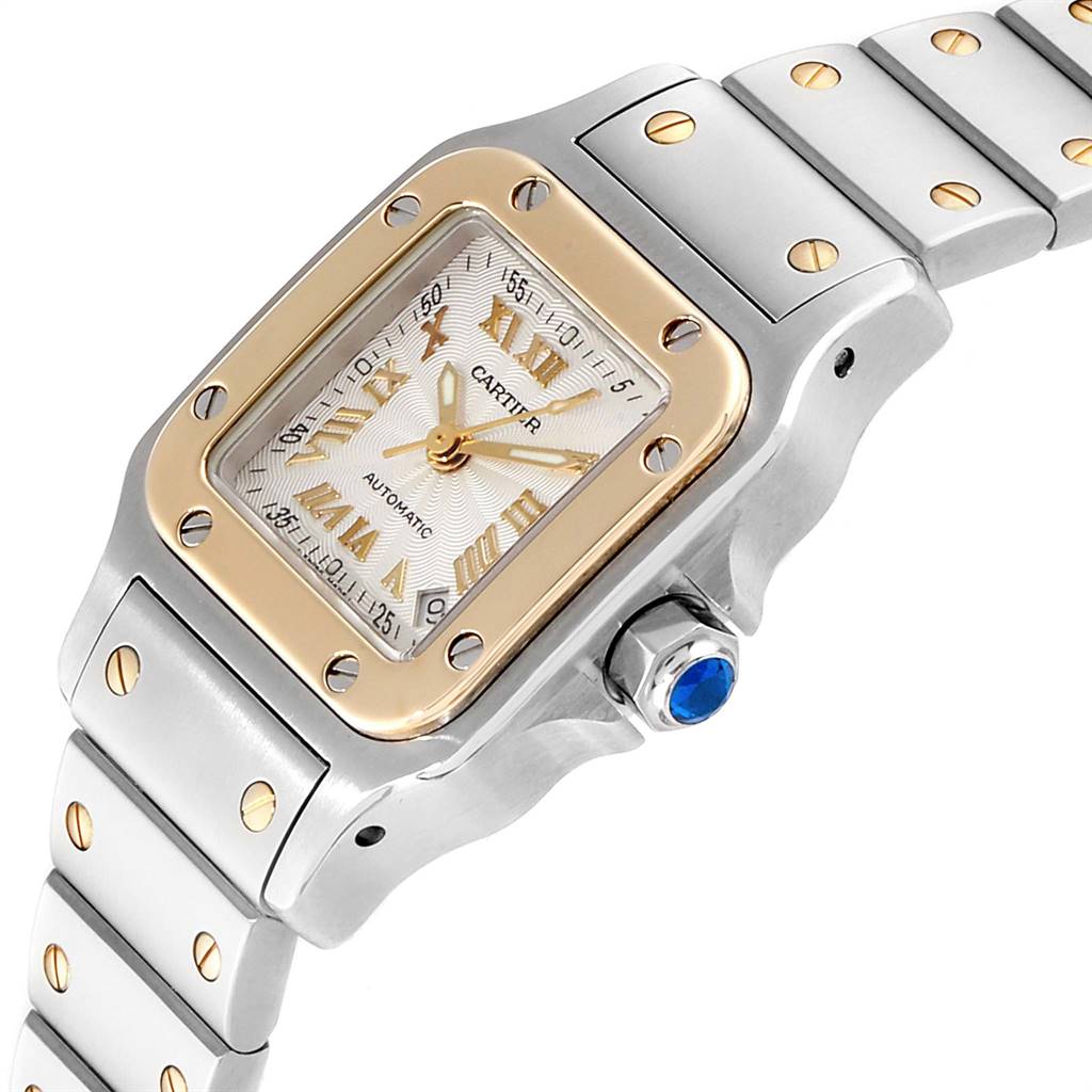 The image shows a close-up of the Cartier Santos W20057C4 Women's Stainless Steel Silver Dial W20057C4 Women's Stainless Steel Silver Dial watch, highlighting its dial, bezel, crown, and bracelet from a side angle.