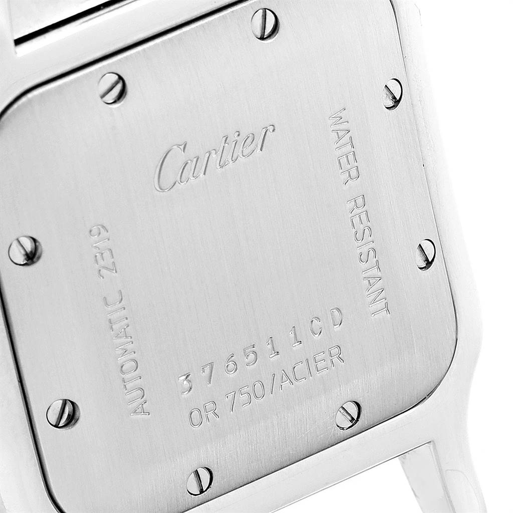This image shows the back case of a Cartier Santos W20058C4 Men's Stainless Steel Silver Dial W20058C4 Men's Stainless Steel Silver Dial watch, highlighting engravings and screws.