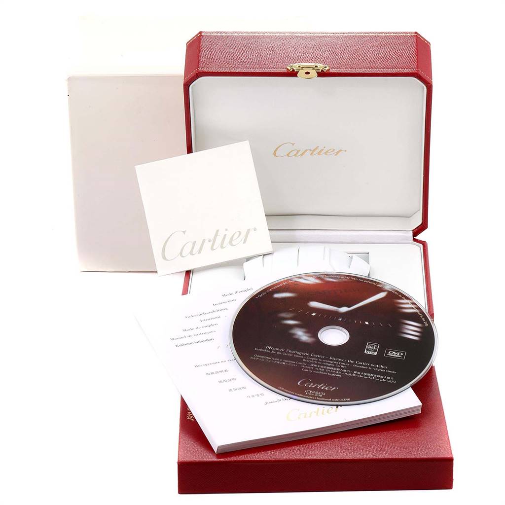 The image shows the packaging and accessories for a Santos model by Cartier, including a box, booklet, and DVD.
