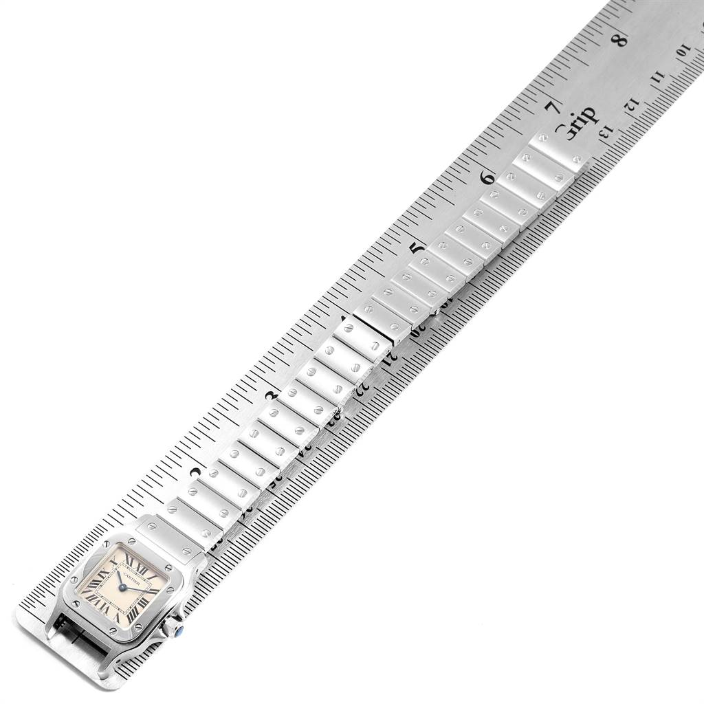 The image shows a Cartier Santos W20056D6 Women's Stainless Steel Silver Dial W20056D6 Women's Stainless Steel Silver Dial watch from an overhead angle, focusing on the watch's face and metal bracelet.