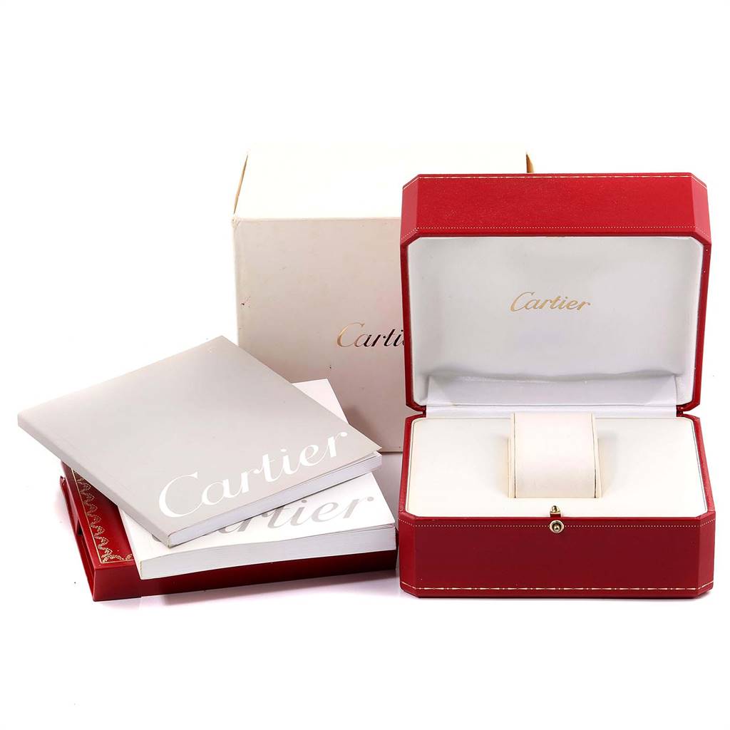The image shows a red Cartier Santos W20056D6 Women's Stainless Steel Silver Dial W20056D6 Women's Stainless Steel Silver Dial watch box, an outer box, and Cartier booklets displayed on a flat surface.