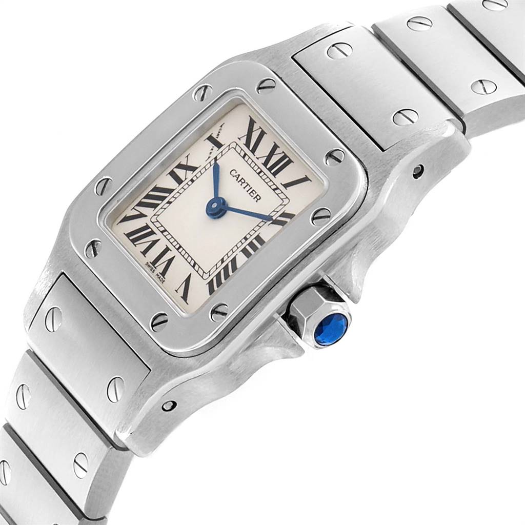 The image shows a close-up angled view of the Cartier Santos W20056D6 Women's Stainless Steel Silver Dial W20056D6 Women's Stainless Steel Silver Dial watch face, bezel, and part of the bracelet with a blue crown.