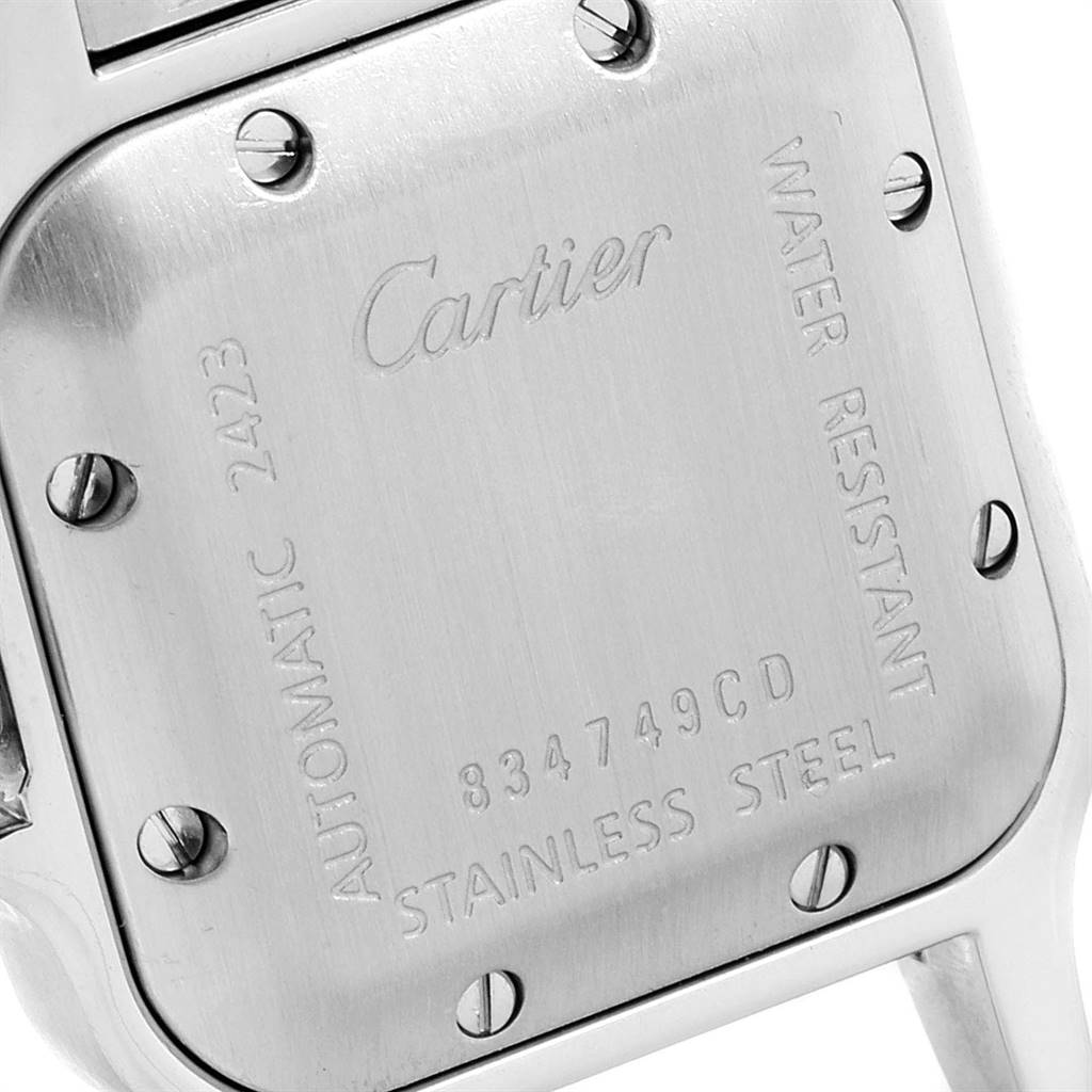 The image shows the back case of a Santos model by Cartier, highlighting its engraving, screws, and water resistance marking.