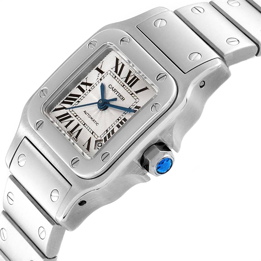 The image shows a close-up angled view of a Santos model watch by Cartier, highlighting the dial, bezel, crown, and part of the bracelet.