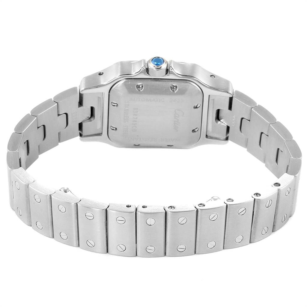 The image shows the back of a Santos model by Cartier, highlighting the bracelet and caseback with exposed screws and a blue crown.