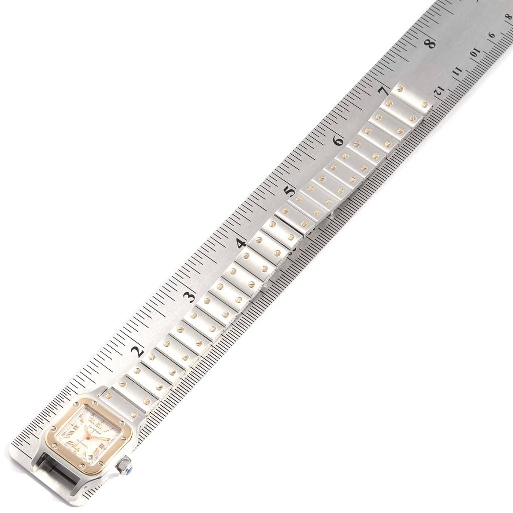 The image shows the face and partial bracelet of a Cartier Santos W20057C4 Women's Stainless Steel Silver Dial W20057C4 Women's Stainless Steel Silver Dial model watch next to a ruler for measurement.