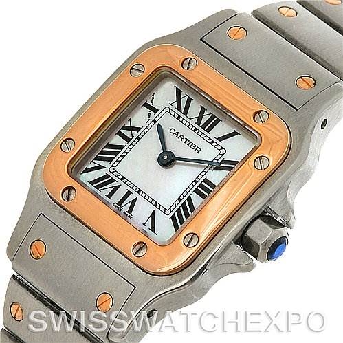 This image shows a top view of the Santos de Cartier watch, highlighting the face, bezel, crown, and part of the metal bracelet.