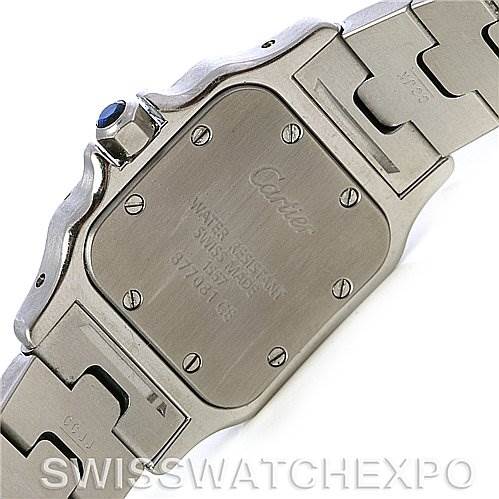The image shows the back case and part of the bracelet of a Santos model by Cartier, including engraved details and screws.