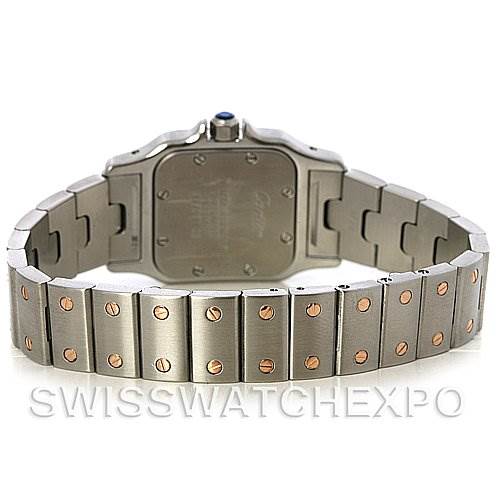 The image shows the back of the Santos model by Cartier, highlighting its stainless steel bracelet and case back.