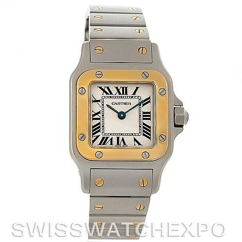 The image shows a front view of the Cartier Santos W20012C4 Women
s Stainless Steel Silver Dial W20012C4 Women
s Stainless Steel Silver Dial watch, highlighting its square face, gold bezel, and metal bracelet with screw details.