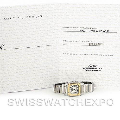 The image shows a front view of the Cartier Santos W20012C4 Women
s Stainless Steel Silver Dial W20012C4 Women
s Stainless Steel Silver Dial watch, positioned in front of its certificate and Best Quality
ity paperwork.