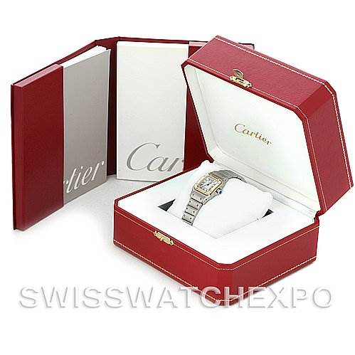 This image shows a Cartier Santos W20012C4 Women
s Stainless Steel Silver Dial W20012C4 Women
s Stainless Steel Silver Dial watch inside its red box, along with booklets or manuals standing next to the box.