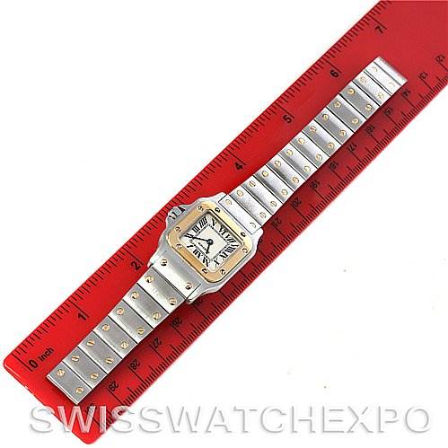 This Cartier Santos W20012C4 Women
s Stainless Steel Silver Dial W20012C4 Women
s Stainless Steel Silver Dial watch is shown from a top-down angle, alongside a ruler for scale.