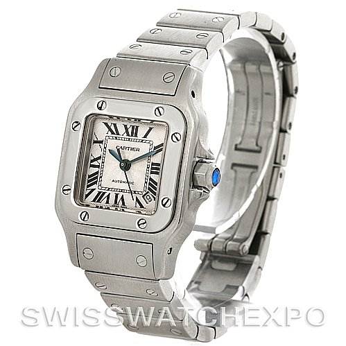 The image shows a front-right angled view of the Cartier Santos W20054D6 Women
s Stainless Steel Silver Dial W20054D6 Women
s Stainless Steel Silver Dial watch, highlighting its square face, bezel, bracelet, and blue cabochon crown.