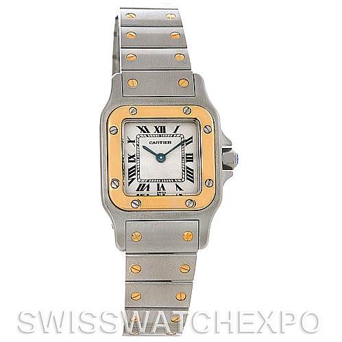The image shows a front view of a Cartier Santos W20012C4 Women
s Stainless Steel Silver Dial W20012C4 Women
s Stainless Steel Silver Dial watch with a silver and gold case, roman numerals, and a metal bracelet with gold screws.